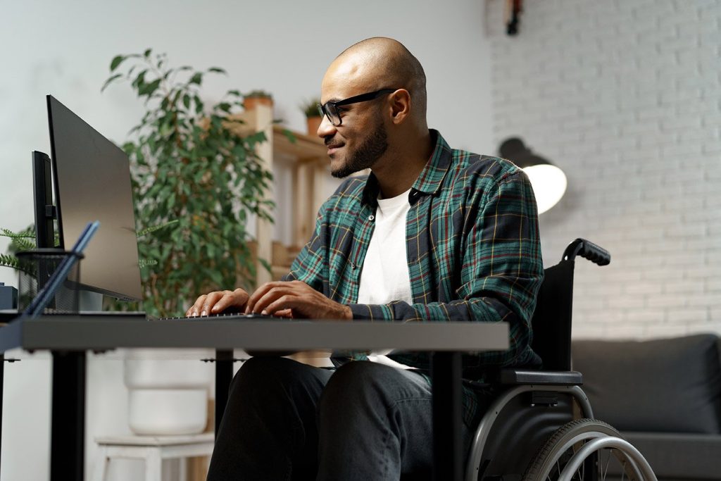 Gen Z man in a wheelchair logs into his online therapy session in Houston Texas
