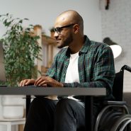 Gen Z man in a wheelchair logs into his online therapy session in Houston Texas