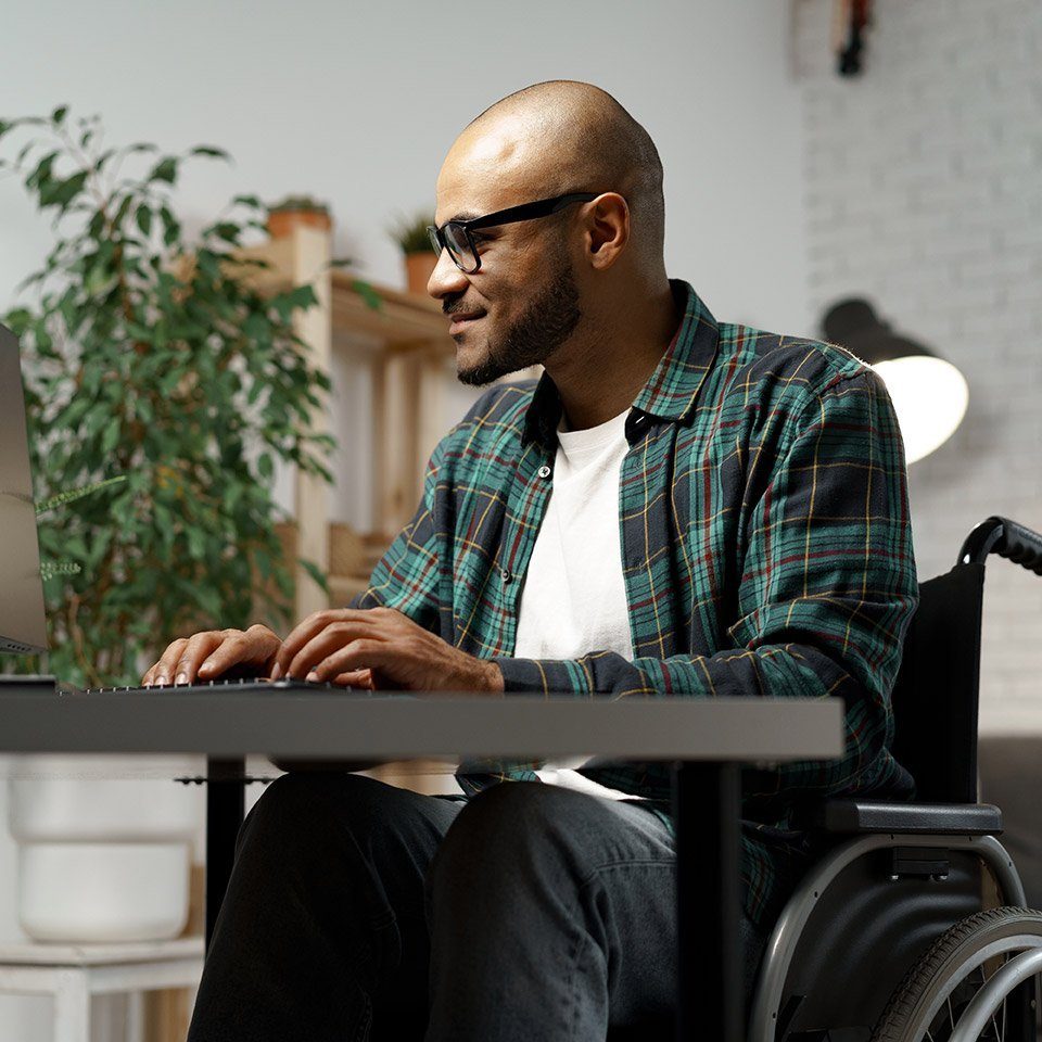 Gen Z man in a wheelchair logs into his online therapy session in Houston Texas